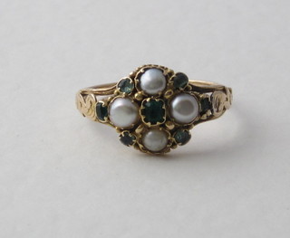A gold dress ring set emeralds and pearls