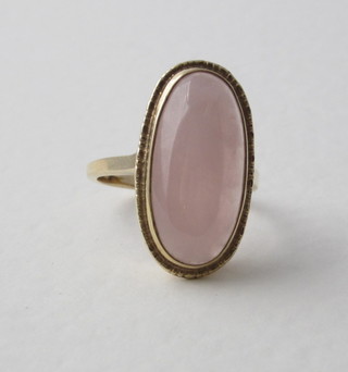 A 9ct yellow gold dress ring set a cabouchon cut pink coloured  stone