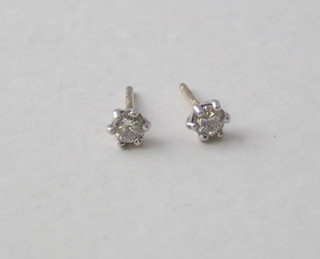 A pair of small diamond ear studs