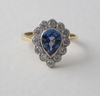 A lady's 18ct yellow gold dress ring set a tear drop sapphire surrounded by diamonds, approx 0.70/1/30ct
