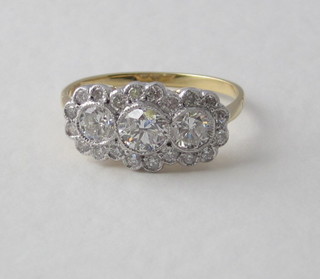 An 18ct yellow gold dress ring set 3 diamonds each surrounded by diamonds, approx 1.25ct