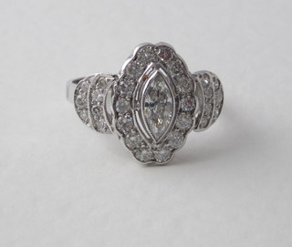 An 18ct white gold dress ring set a marquees shaped diamond surrounded by numerous diamonds, approx 1.60ct