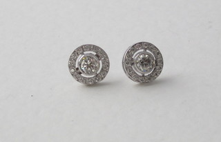 A pair of circular diamond earrings, approx 0.72ct