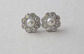 A pair of diamond and pearl set earrings