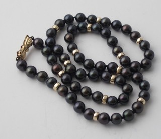 A rope of black pearls with 9ct gold clasp