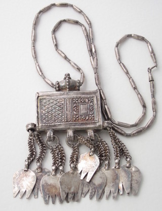 An Eastern silver pendant hung on a silver chain