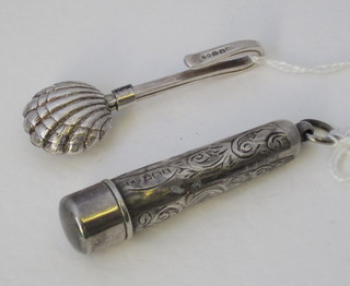 A silver cheroot holder together with a matching case and a silver napkin clip in the form of a clam shell