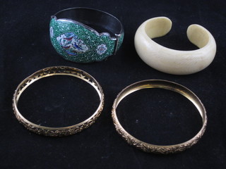 An ivory bangle, a Persian style enamelled bangles and 2 gilt metal bangles