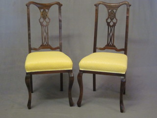 A set of 4 Edwardian pierced slat back dining chairs with  upholstered seats, raised on cabriole supports