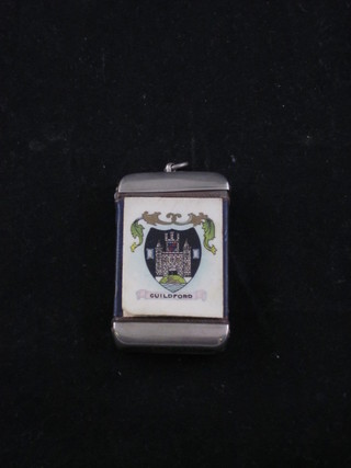A silver plated and enamelled vesta case decorated The Arms of Guildford and a black and white photograph of the High Street  Guildford