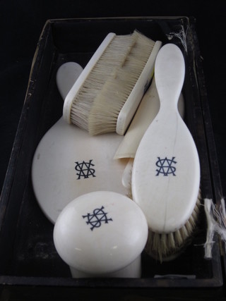 A 8 piece ivory backed dressing table set comprising a pair of hair brushes, pair of clothes brushes, button hook, hand mirror,  shoe horn and dome shaped dressing table jar