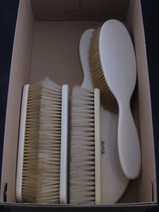 An ivory backed hand mirror, 3 ivory backed clothes brushes and  an ivory backed hair brush