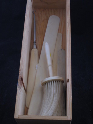 An ivory handled table brush, an ivory handled button hook and  3 ivory letter openers
