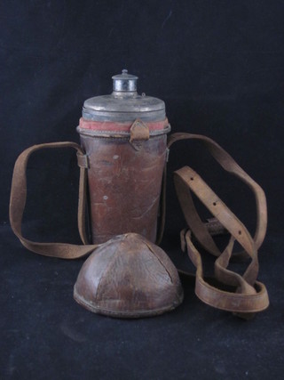 A silver plated hunting flask and 2 cylindrical beakers contained  in a leather case