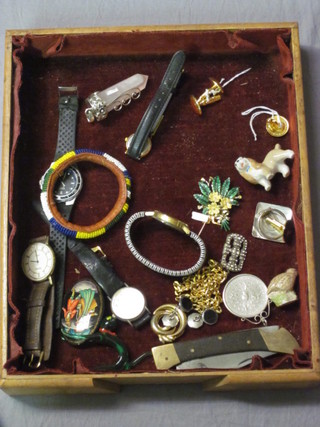A box containing a collection of costume jewellery, wristwatches etc