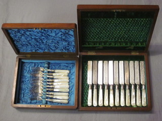 A set of 11 Victorian silver plated fruit knives with engraved blades and mother of pearl handles, contained in a walnut canteen  box, together with a set of 10 Victorian silver fruit forks with  mother of pearl handles contained in a walnut canteen box