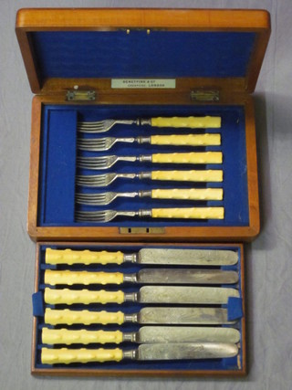 A set of 6 Victorian silver plated dessert knives and forks with ivory handles contained in a walnut canteen box