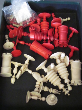 A red and white carved ivory chess set, 1 white pawn missing,  together with an ivory travel chess set, 1 pawn missing