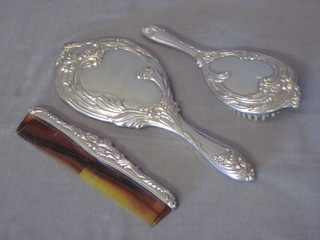 A silver plated 3 piece dressing table set comprising hand mirror, hair brush and comb