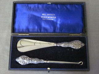A silver handled button hook and ditto shoe horn, cased