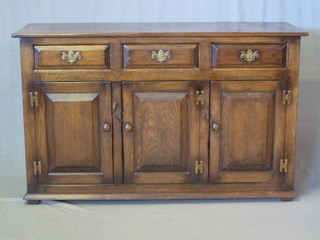 A 17th/18th Century style oak dresser base fitted 3 drawers  above a triple cupboard 54"