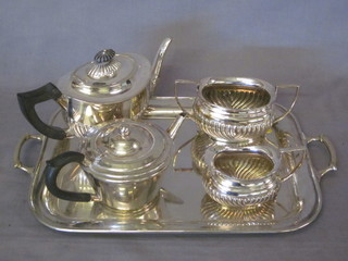 A silver plated 3 piece tea service with demi-reeded decoration, a  circular silver plated teapot and a circular twin handled tea tray