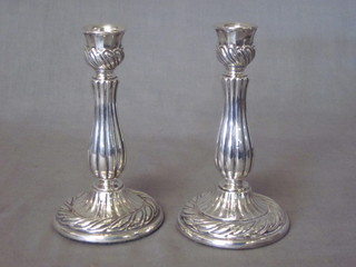 A pair of embossed silver candlesticks 5"