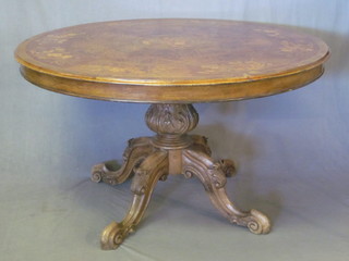 A Victorian style circular inlaid mahogany breakfast table, raised on a carved column and tripod base 52"