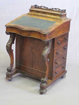 A Victorian figured walnut Davenport of serpentine outline, fitted a stationery box with hinged lid, the pedestal fitted 4 long  drawers and raised on cabriole supports 20"