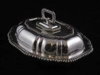 An oval silver plated entree dish and cover with gadrooned  border