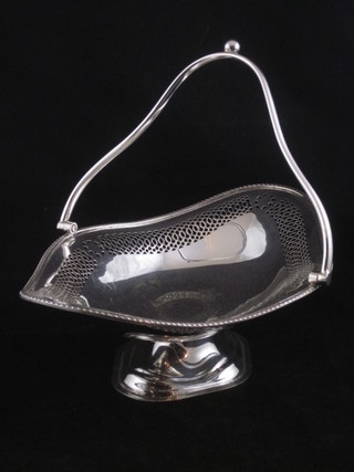 A pierced boat shaped silver plated cake basket with swing handle