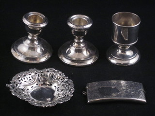An Edwardian engraved silver card case Birmingham 1922, a pierced silver heart shaped dish 3 1/2", a pair of silver stub  candlesticks and a cylindrical silver dish holder