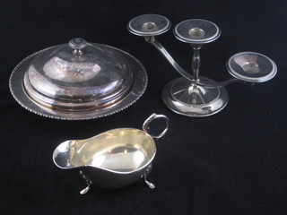 A pair of silver plated 3 light candelabrum, a silver plated  muffin dish and cover and a sauce boat