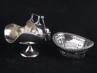 A large silver plated sugar scuttle and an oval pierced basket with bead work border 7"