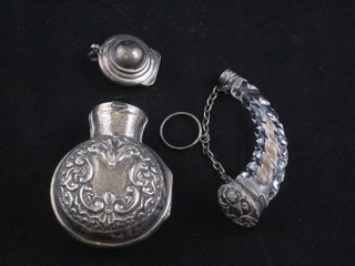 A cut glass scent bottle in the form of a horn with silver plated mount 3" and an Edwardian green glass salts bottle contained in  an embossed silver case with hinged lid, f,
