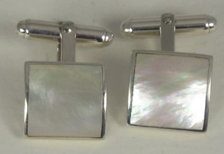 A pair of square silver and mother of pearl mounted cufflinks