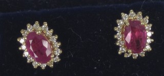 A pair of 18ct yellow gold earrings set rubies and diamonds