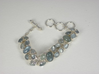 A silver and aquamarine bracelet