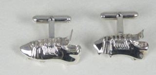 A pair of silver cufflinks in the form of football boots