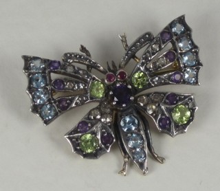A gold brooch in the form of a butterfly set sapphires, amethyst  and diamonds