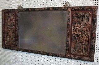 A rectangular bevelled plate mirror contained in a carved Oriental hardwood frame, flanked by 2 carved panels 45"