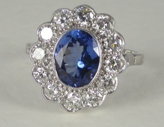 An 18ct white gold dress ring set an oval Tanzanite surrounded  by diamonds, approx 0.80/1.90ct