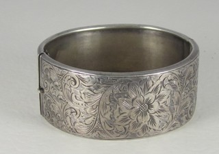 An engraved silver bangle and silver filigree brooch