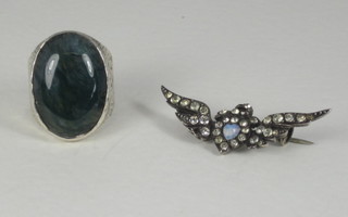 A silver ring set a cabouchon cut stone together with an opal set  brooch