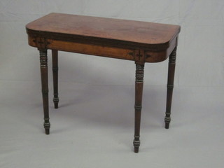 A 19th Century D shaped mahogany card table with ebony  stringing, raised on ring turned supports 35"