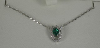 A Pravins pendant set an emerald and diamonds