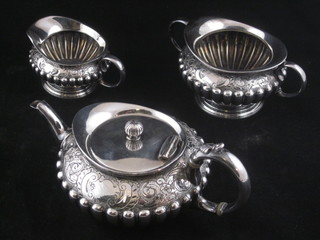 A Victorian Britannia metal 3 piece Bachelor's tea service of  melon form with demi-reeded decoration comprising teapot, lid f,  twin handled sugar bowl and cream jug