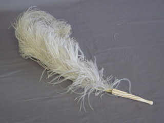 An ostrich feather fan with ivory handle