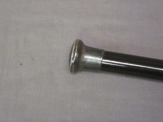 A gentleman's ebony walking cane with silver knob purchased  at Harrods Man Shop