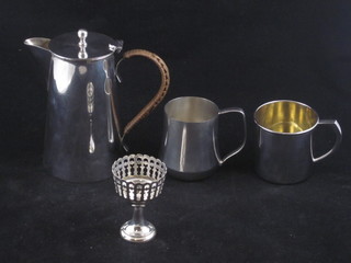A cylindrical silver plated hotwater jug, 2 silver plated christening tankards and an egg cup